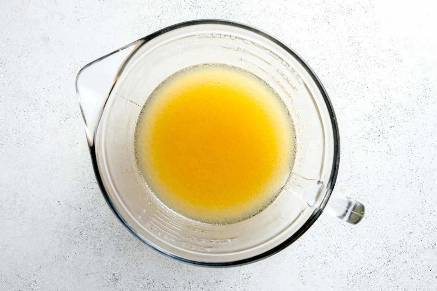 Microwave Safe Measuring Bowl with Chicken Stock and White Rice for Microwave Arroz Verde Recipe