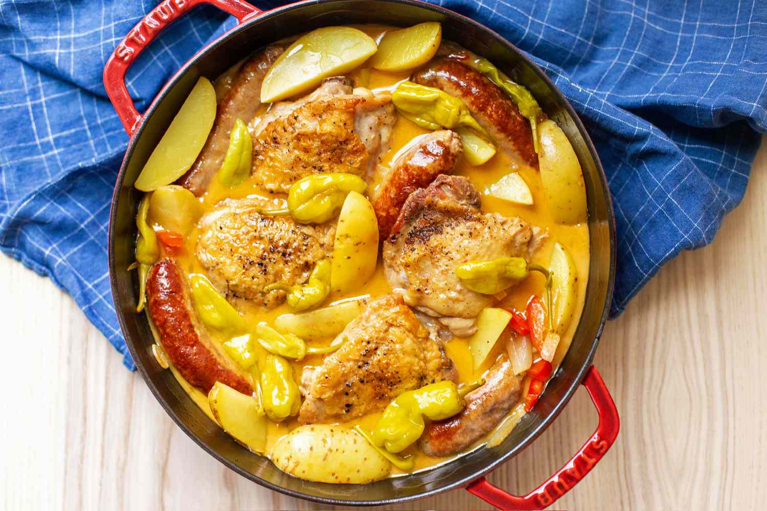 Chicken scarpariello in a red Dutch oven 