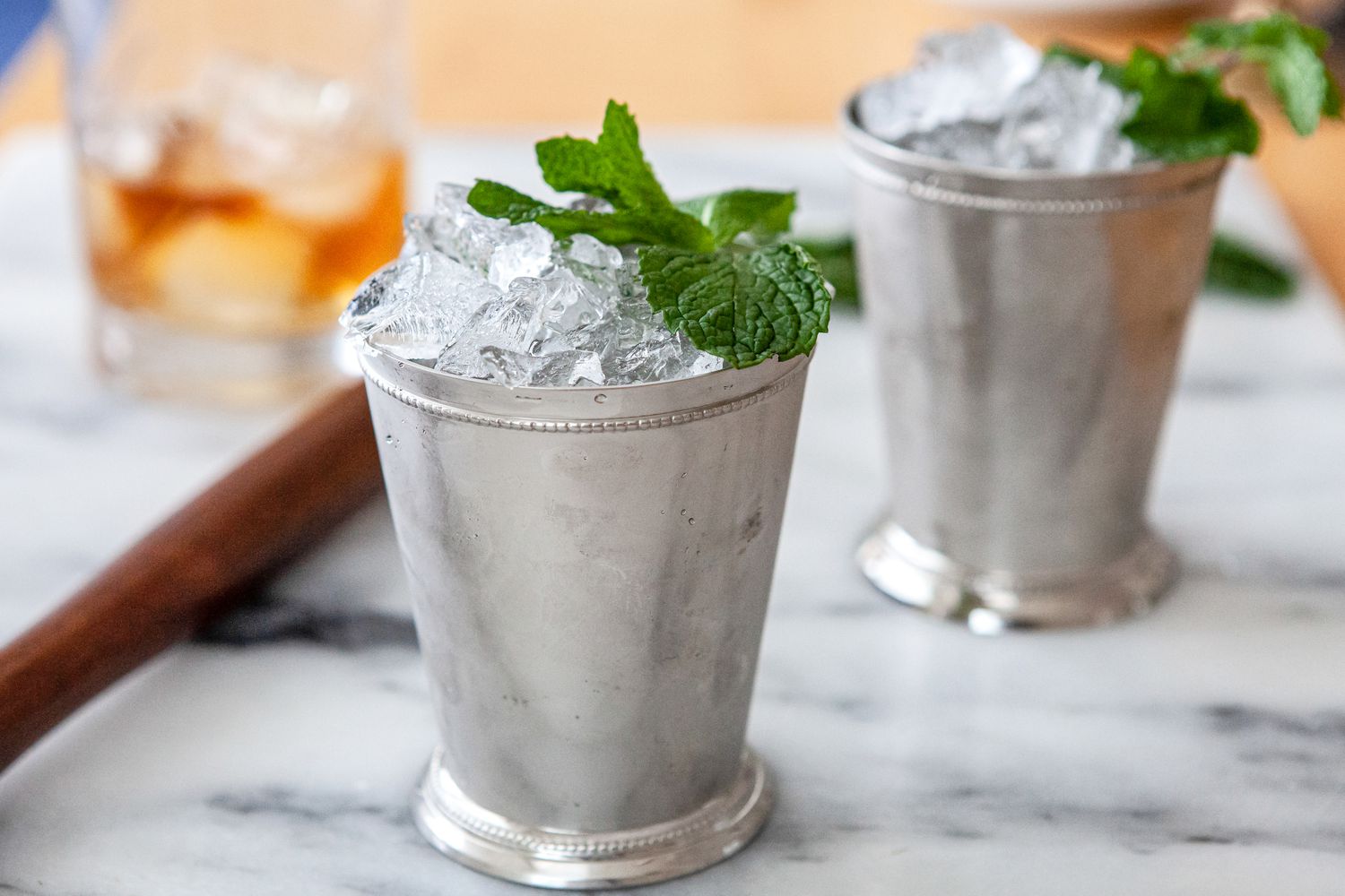 Two Mint Julep Cocktails topped with mint.