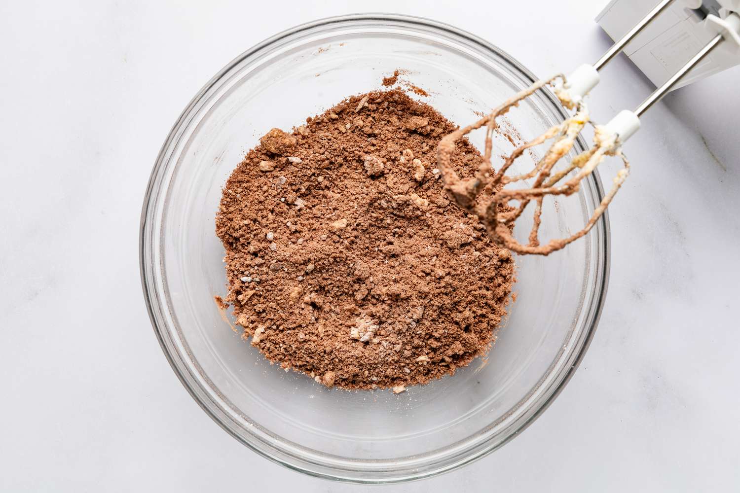 butter, powdered sugar, cocoa powder, and salt mixed together in a bowl for devil's food cake recipe