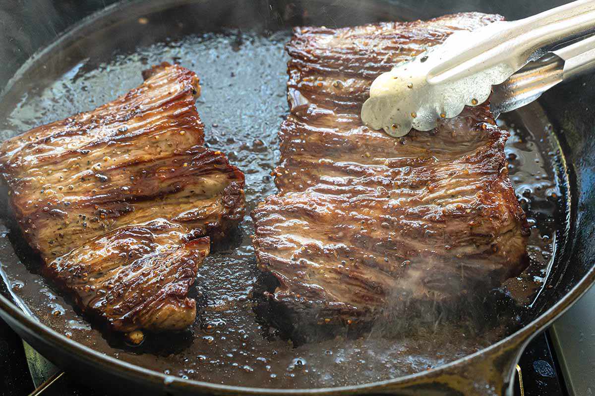 How to Cook Skirt Steak on the Stovetop - searning steak in pan