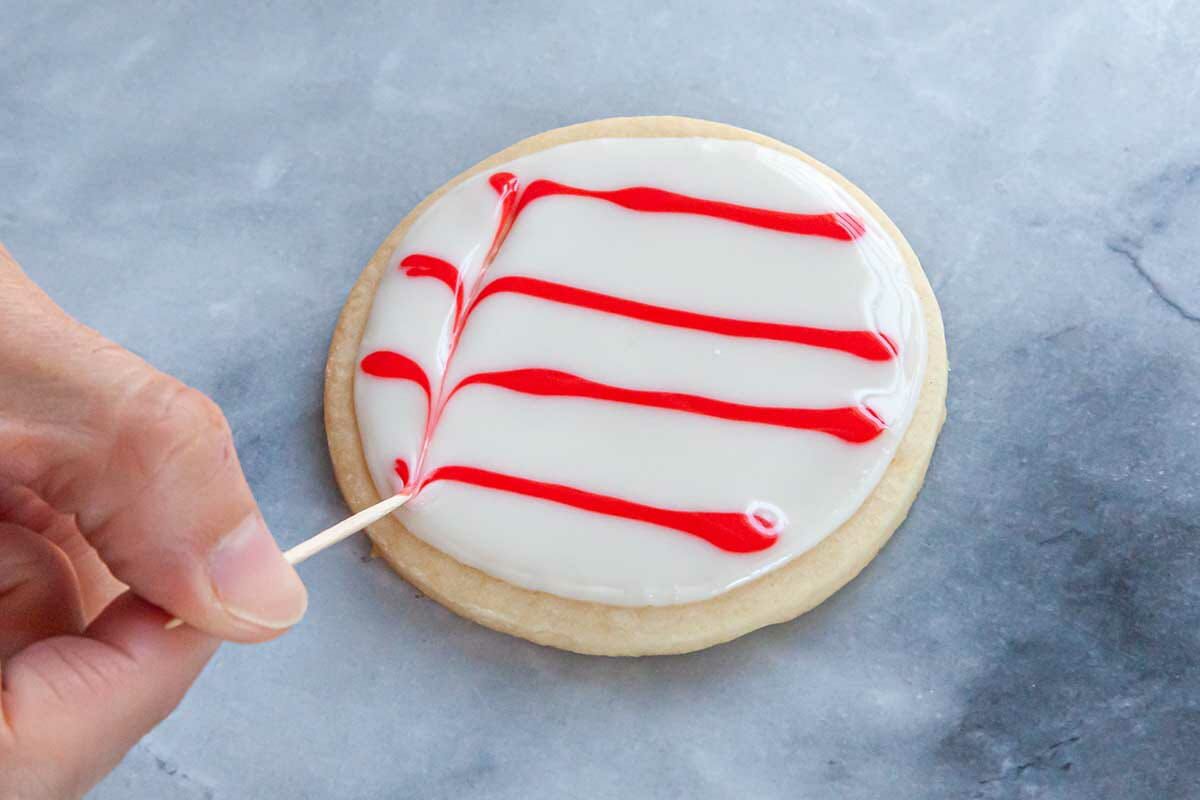 Red and white Royal icing decorate a sugar cookie.