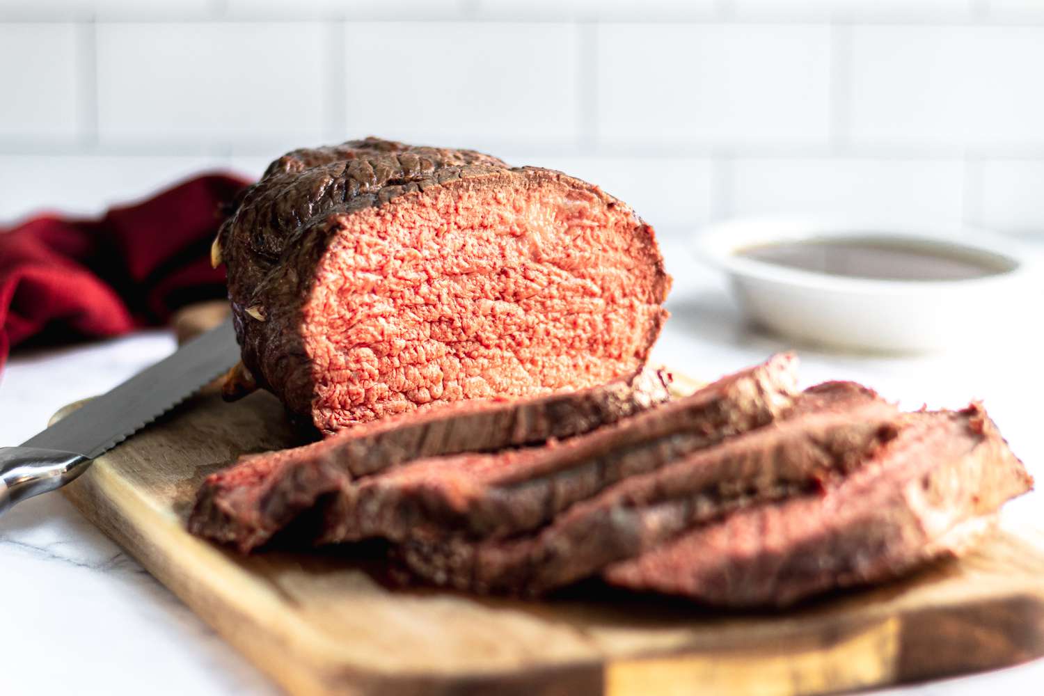 A sliced roast beef cooked to medium rare beef temperature.