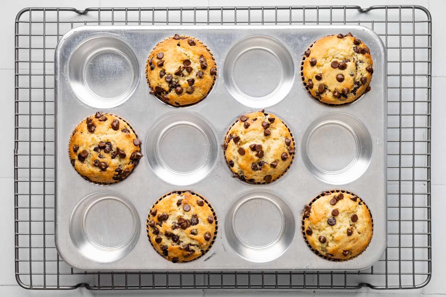 Banana Chocolate Chip Muffins in a Baking Tin on a Cooling Rack