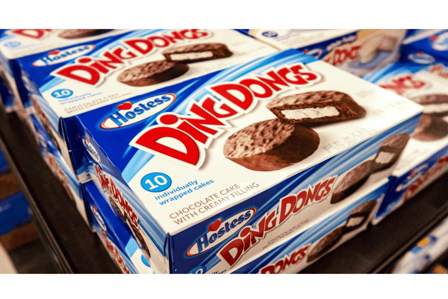 Boxes of Hostess Ding Dongs chocolate cakes displayed on a shelf