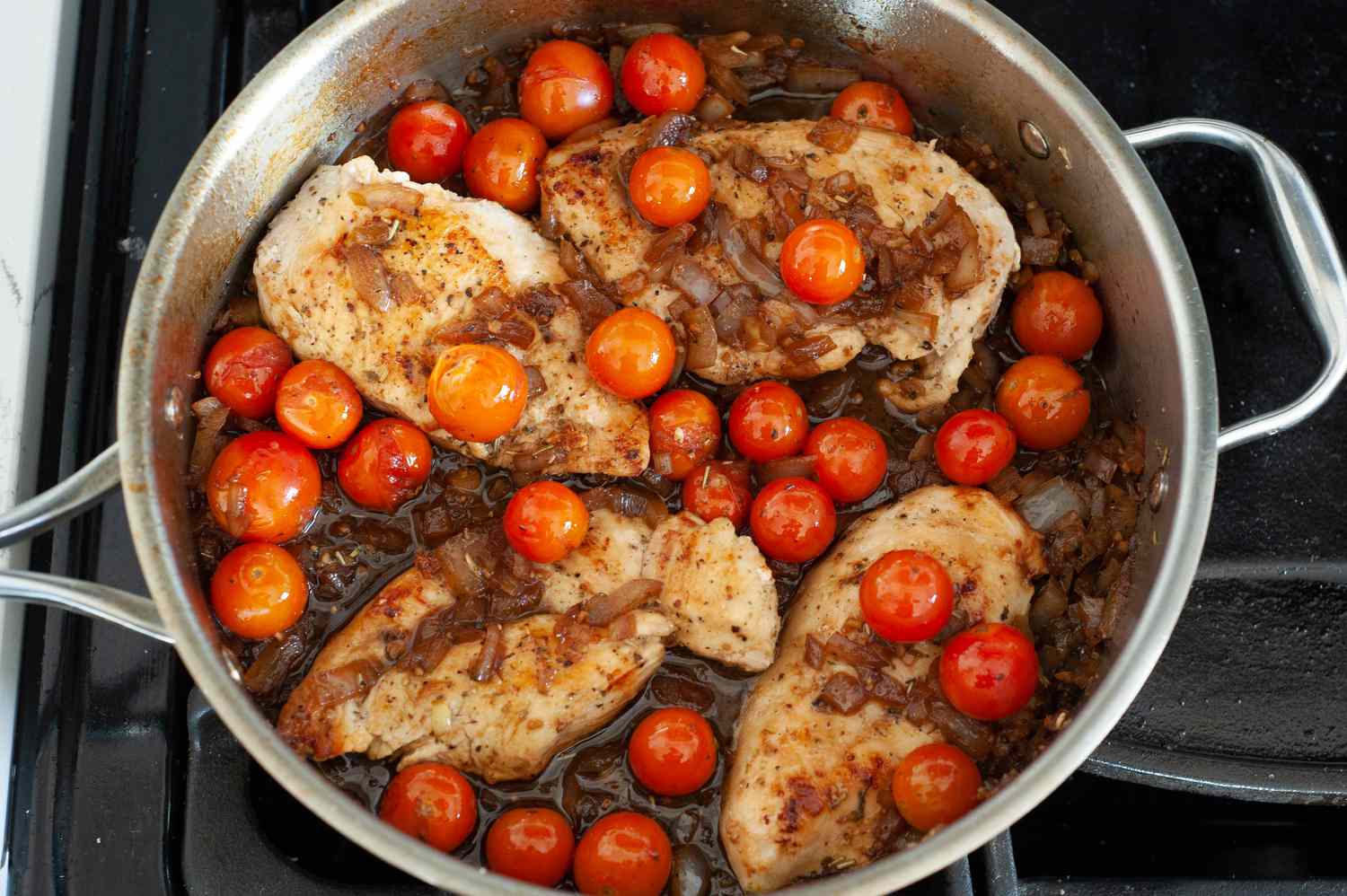 Nestle chicken back into skillet.