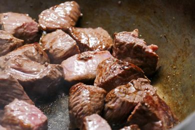 Cooking beef cubes in a pan