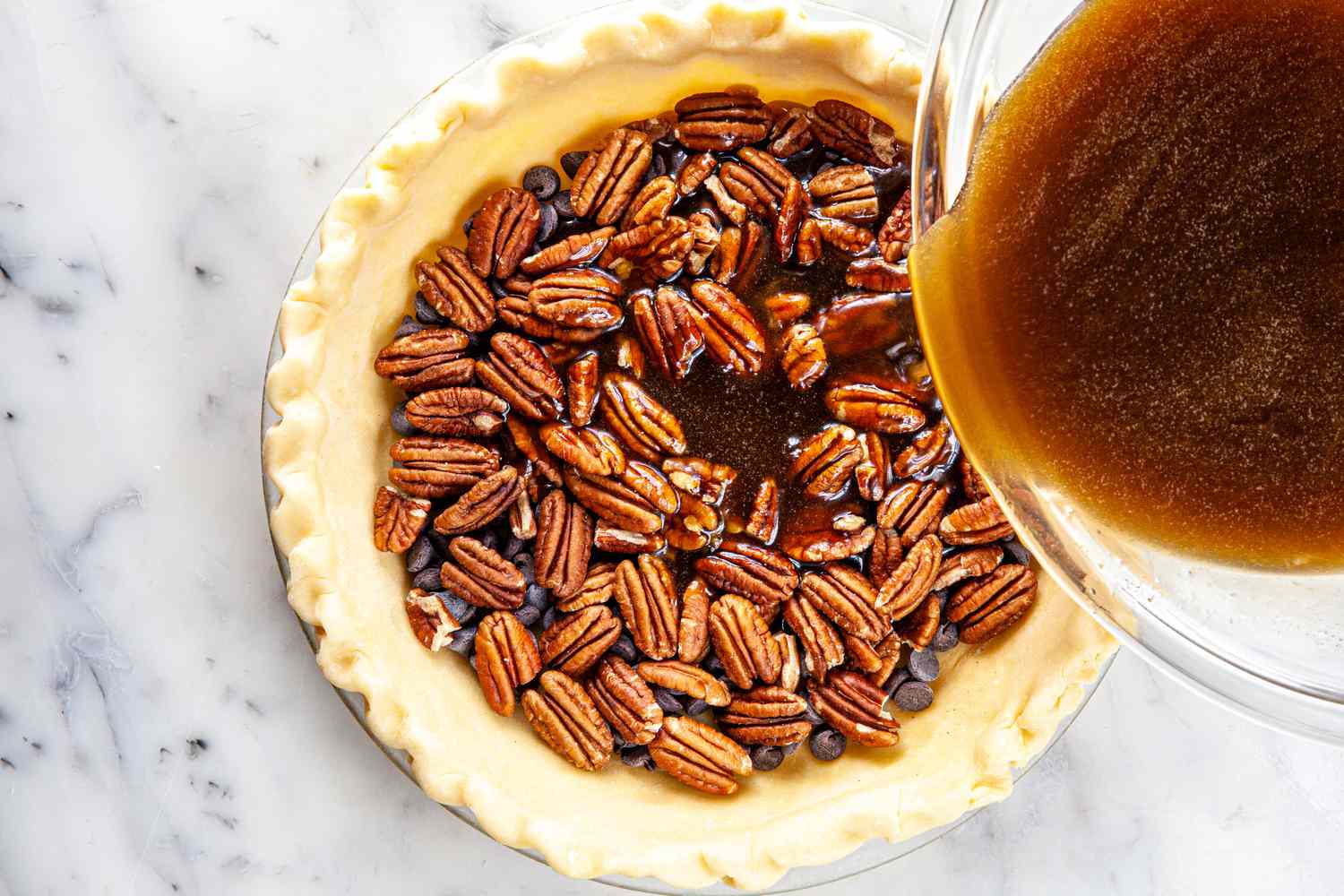 Filling added to a pie crust for chocolate bourbon pecan pie.