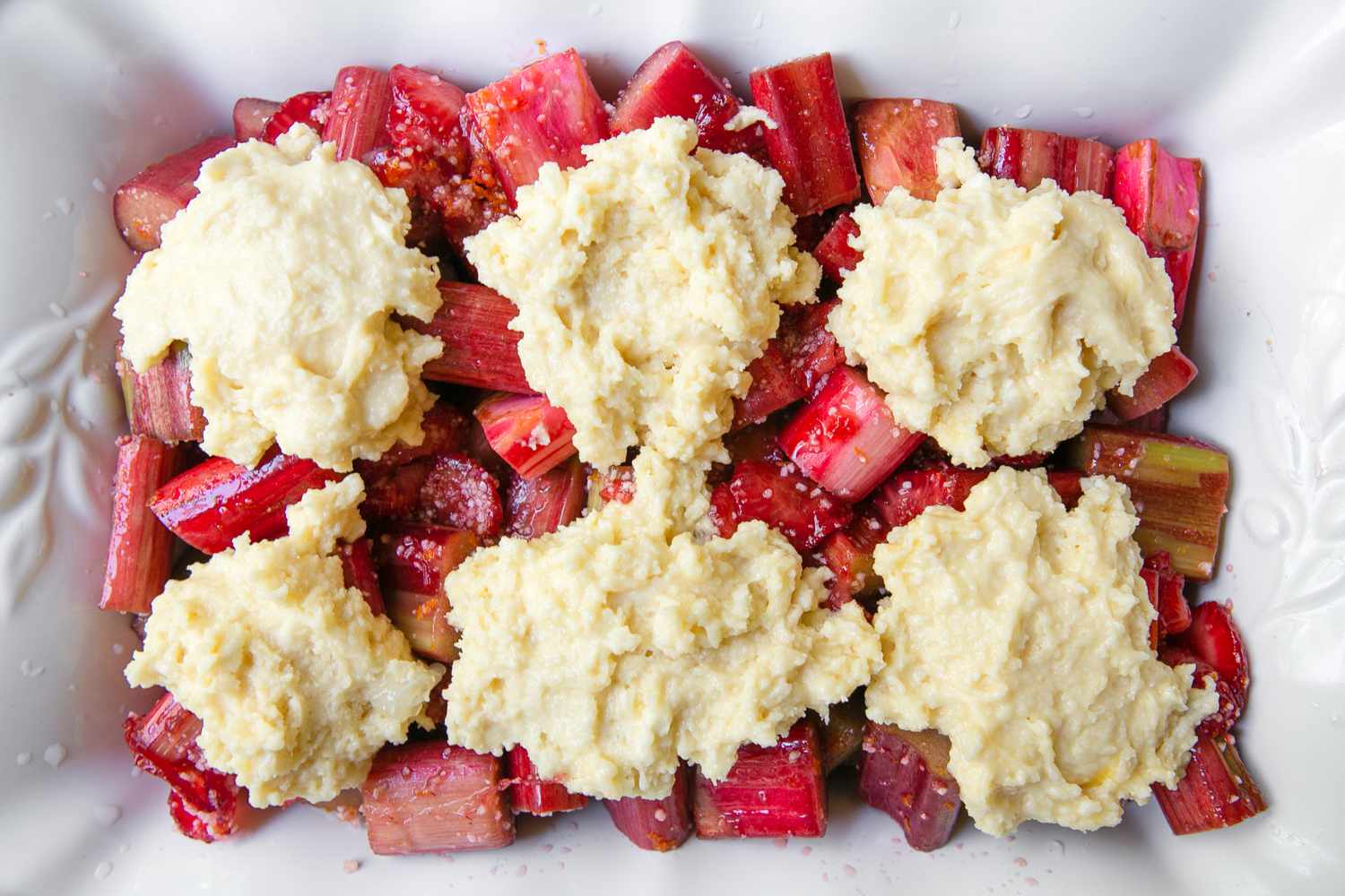 Strawberry Rhubarb Filling Added to Casserole Dish Topped With the Cobbler Dough (Placed as Six Portions)