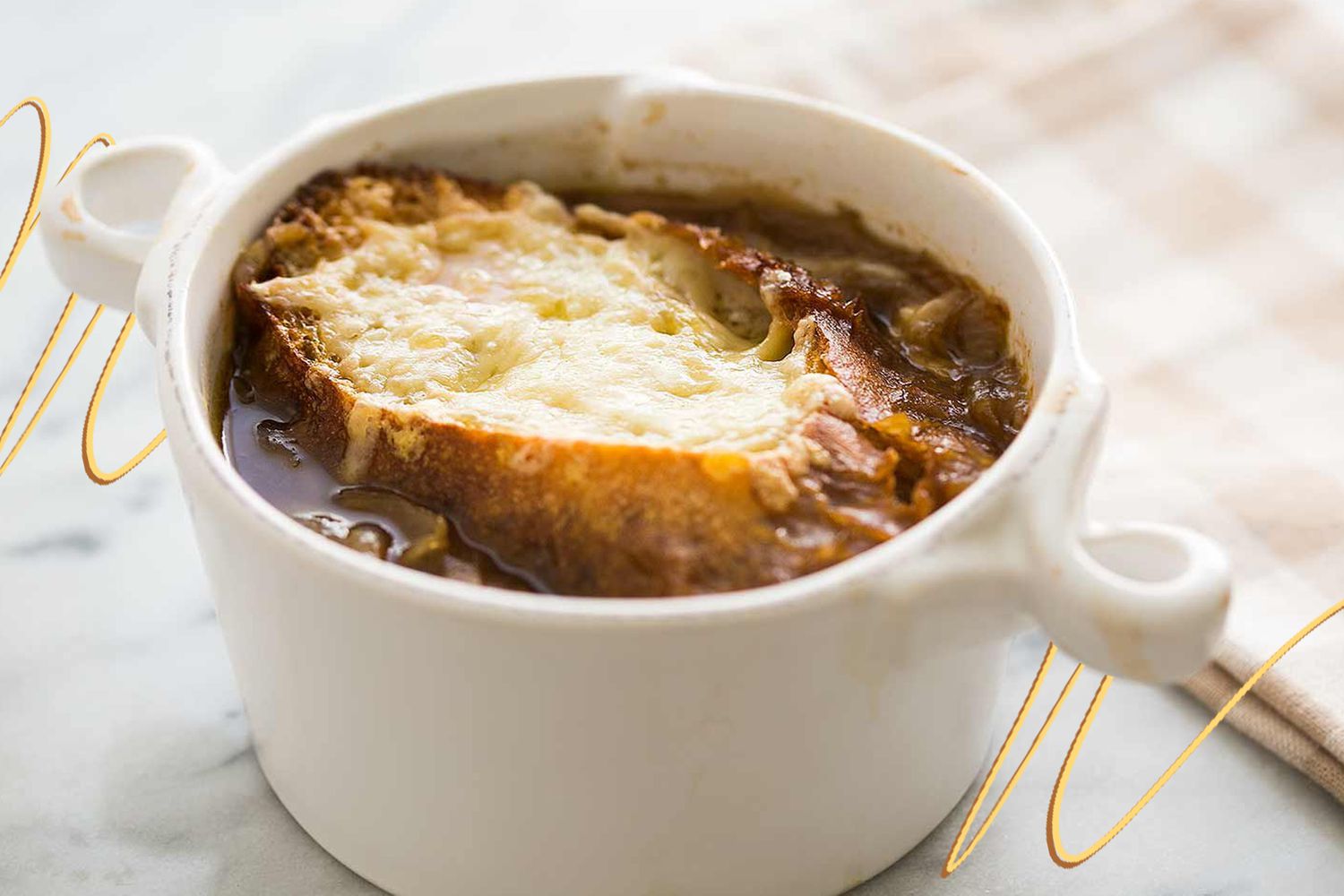 Photo of Simply Recipe's most requested soup: a French onion soup (in a white handled ramekin), and on the edges of photo, yellow and light brown lined illustrations