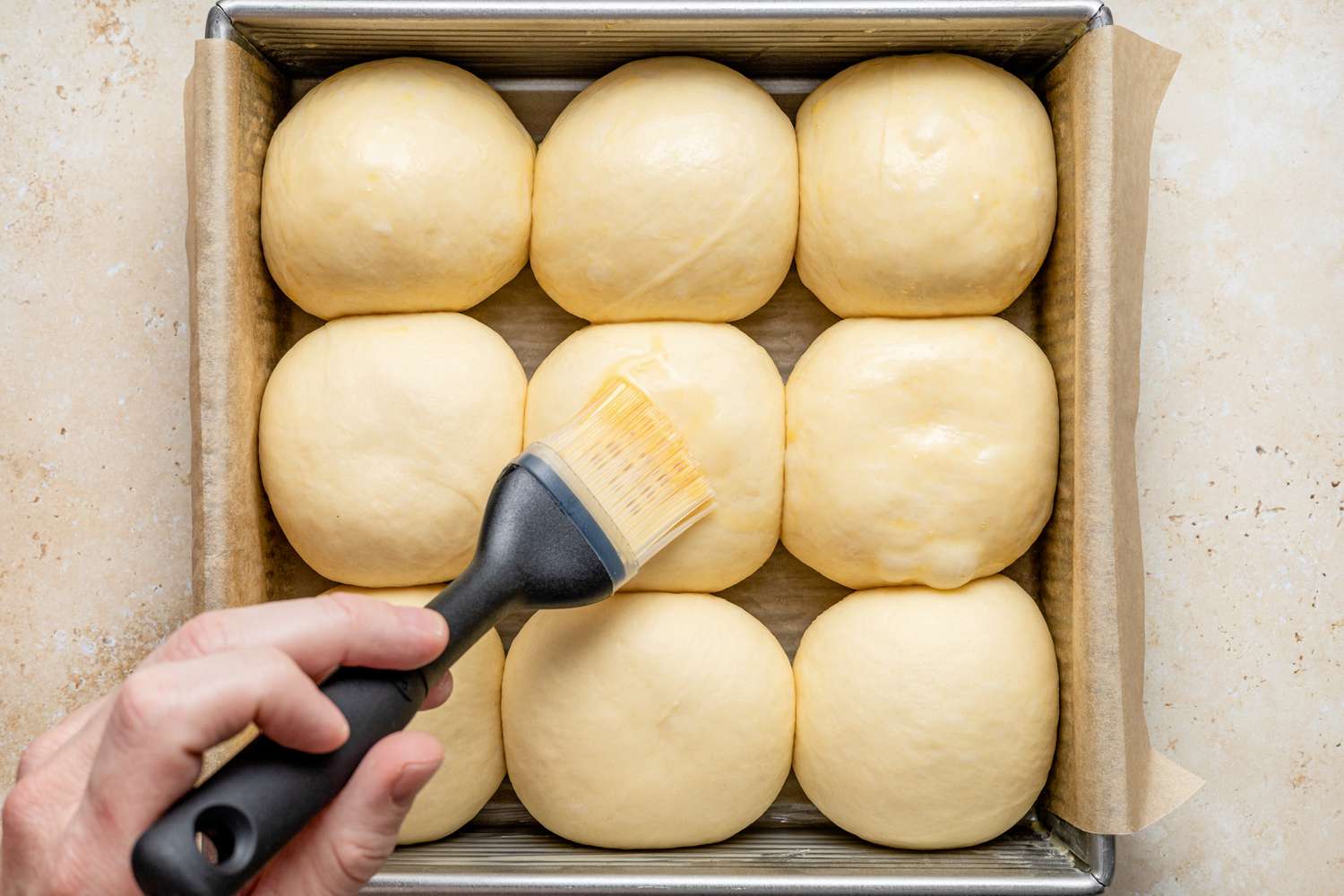 Egg Wash Applied to Risen Milk Bread Rolls 