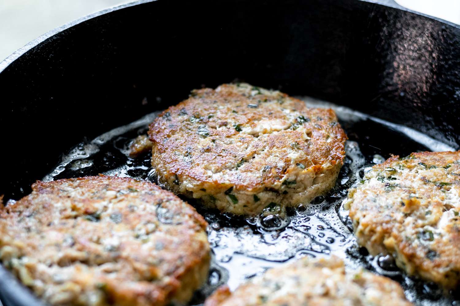 Pan frying tuna patties.