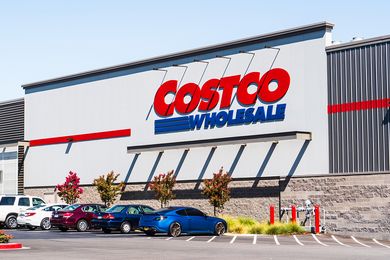 The exterior of a Costco Wholesale store with cars parked in front of it
