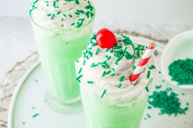 Copycat Shamrock Shake with green sprinkles, a cherry, and a straw.
