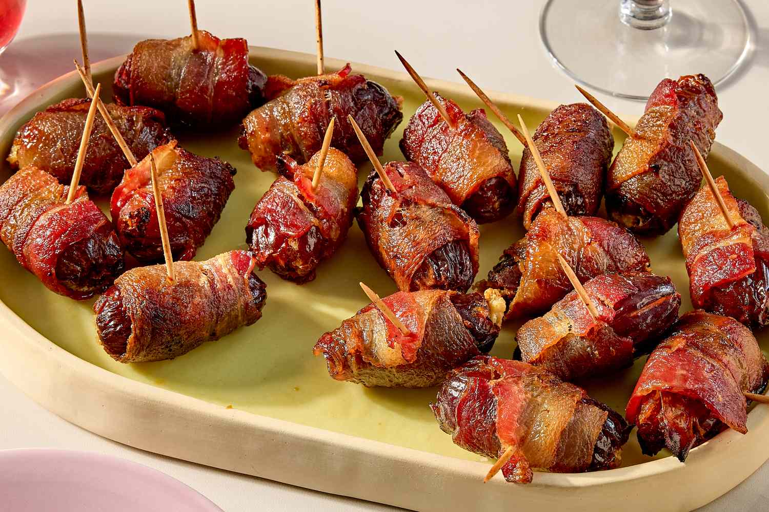 A platter of baconwrapped dates served with toothpicks