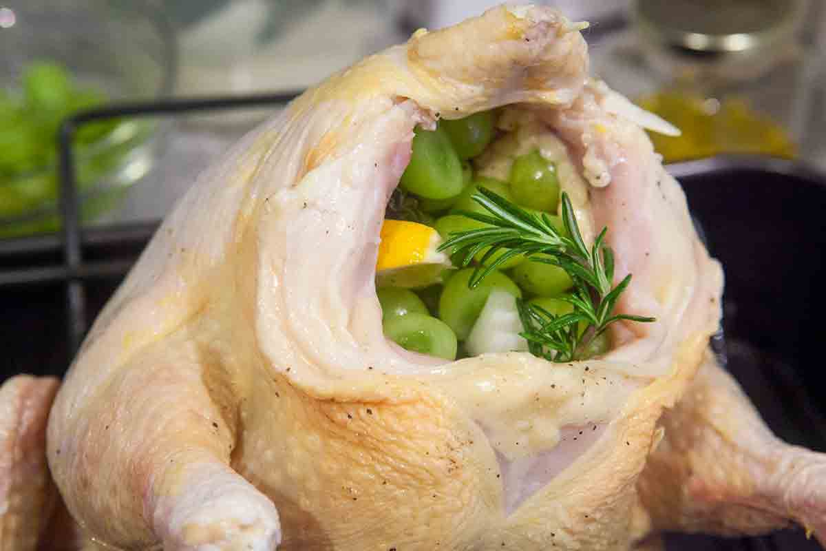 stuff whole raw chicken with grapes lemon herbs
