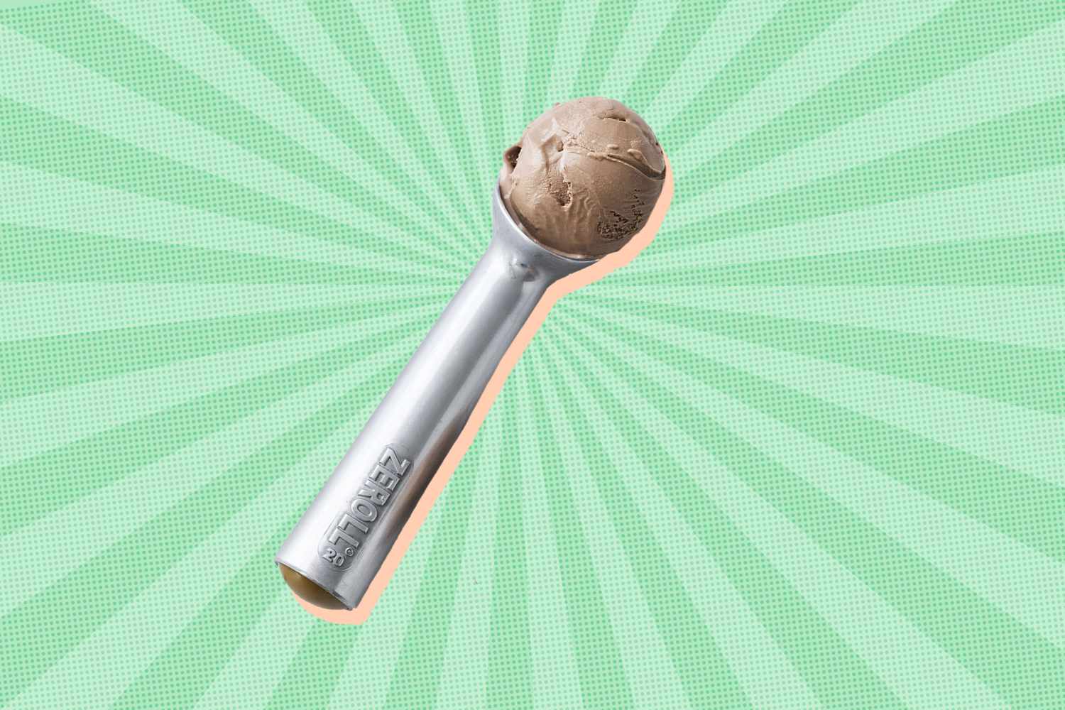 A metal ice cream scoop containing a scoop of brown ice cream displayed against a green radial background