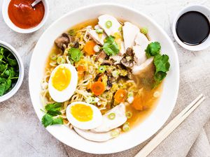 Easy Chicken Ramen Recipe with Noodles and poached eggs in a round bowl
