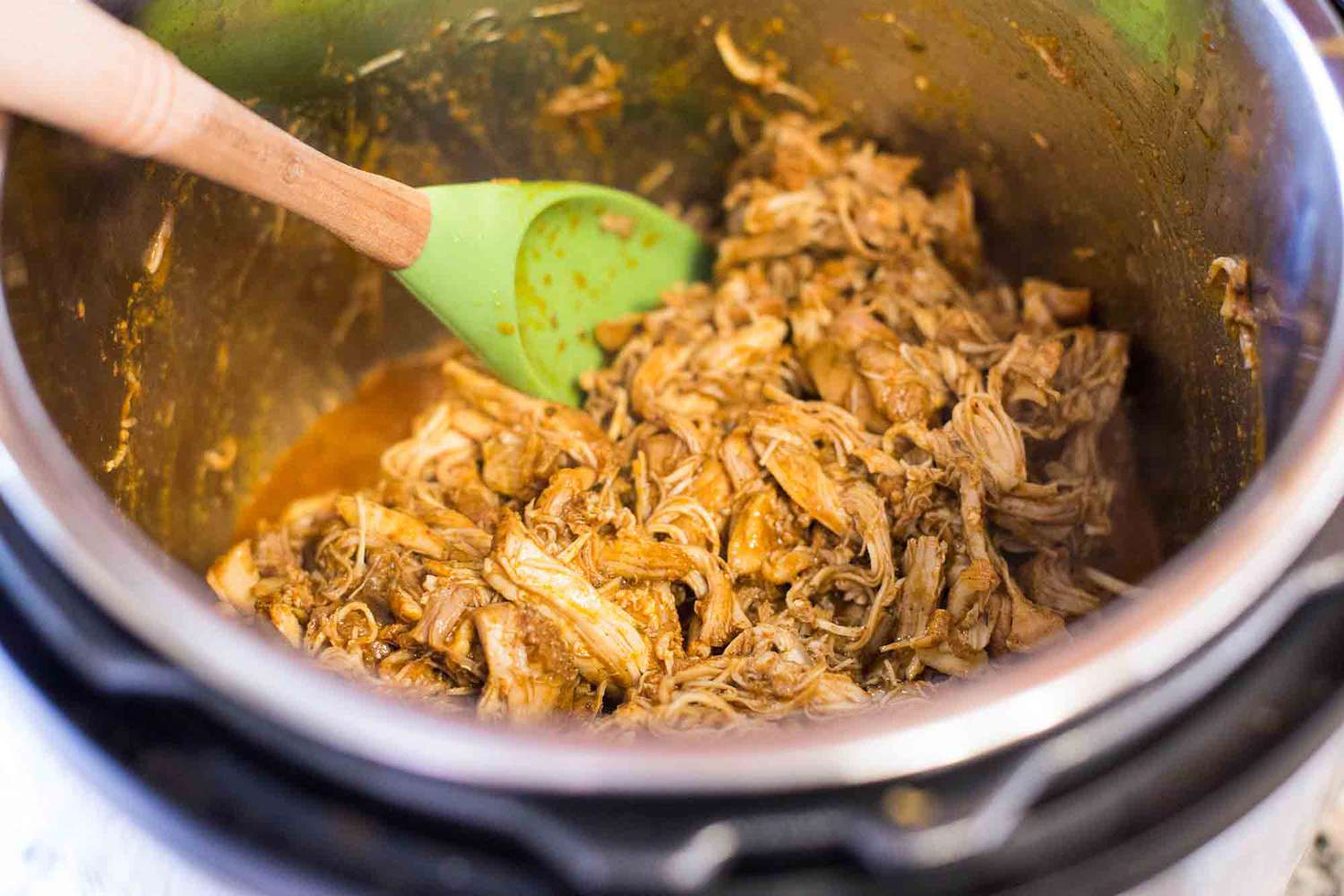 How to Make Chicken Taco Meat in the Pressure Cooker combine the chicken and the juices