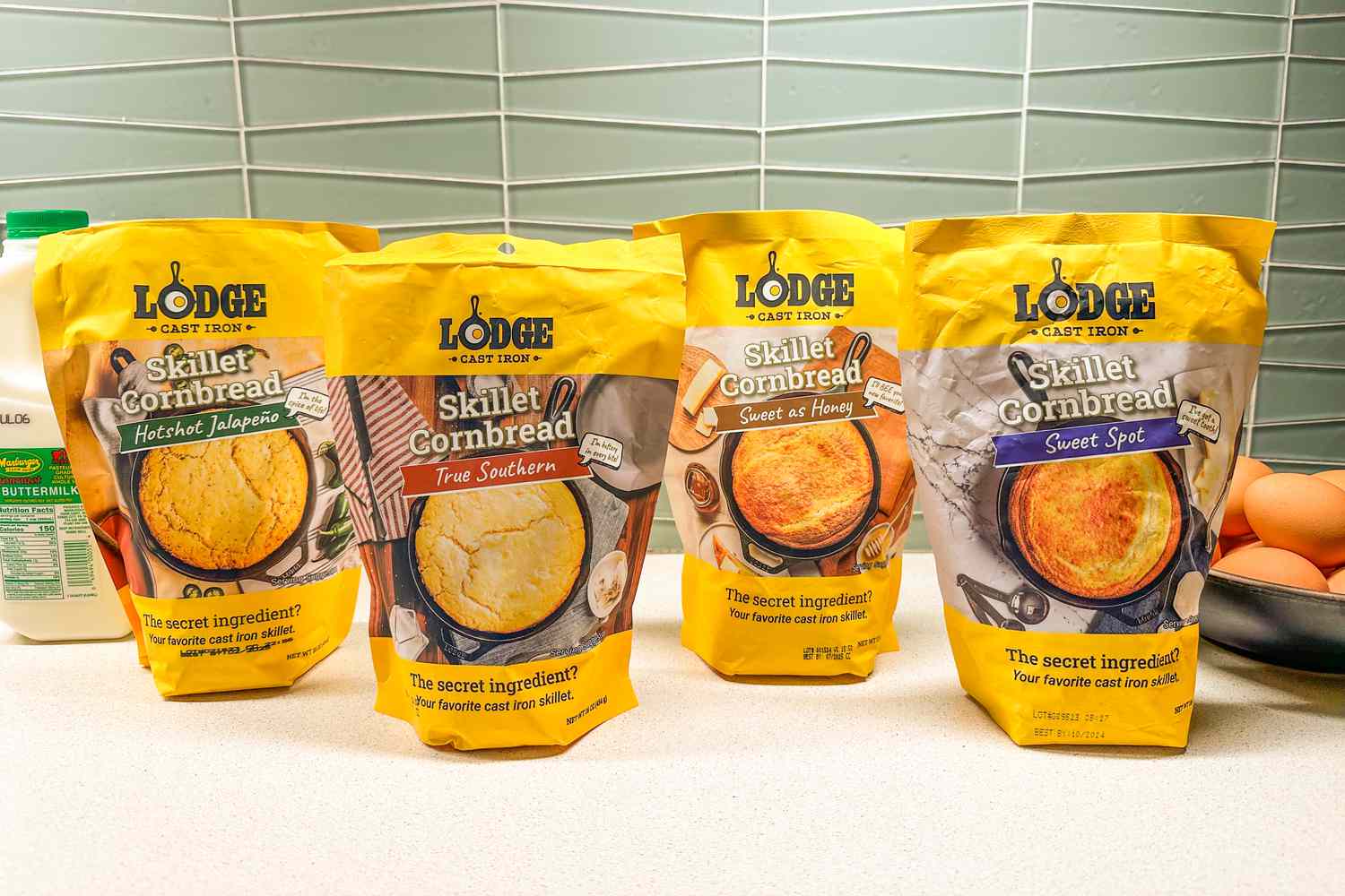 All four cornbread mixes in their bags on a counter