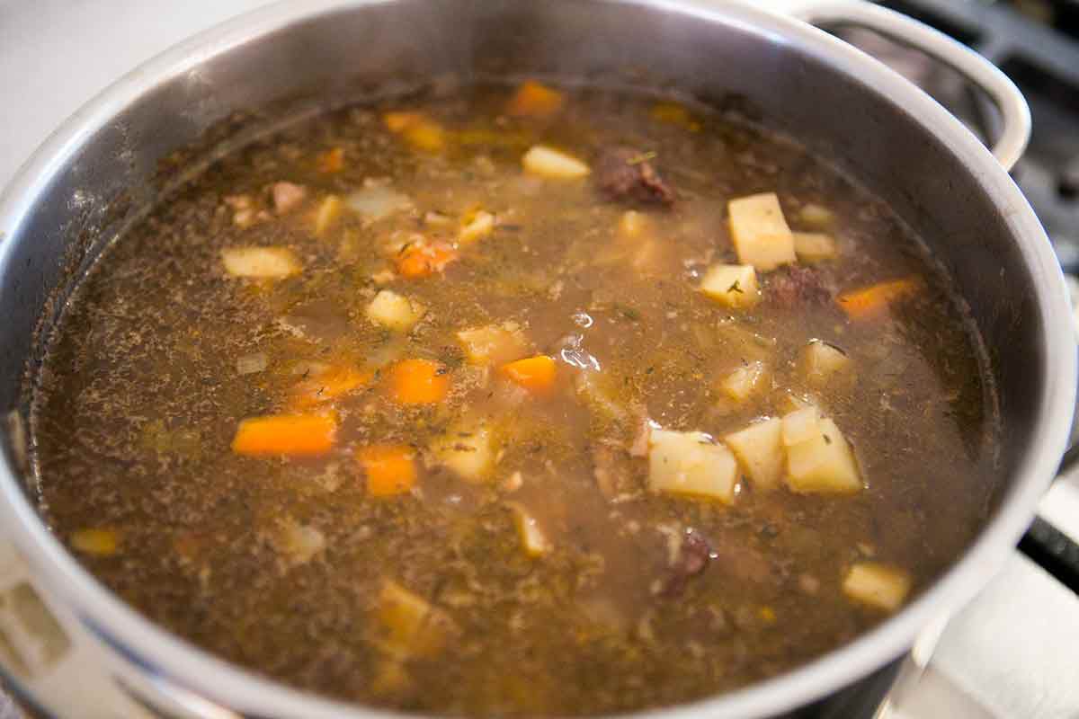 Simmer the beef stew with the carrots, onions, and potatoes until the vegetables and beef are both tender