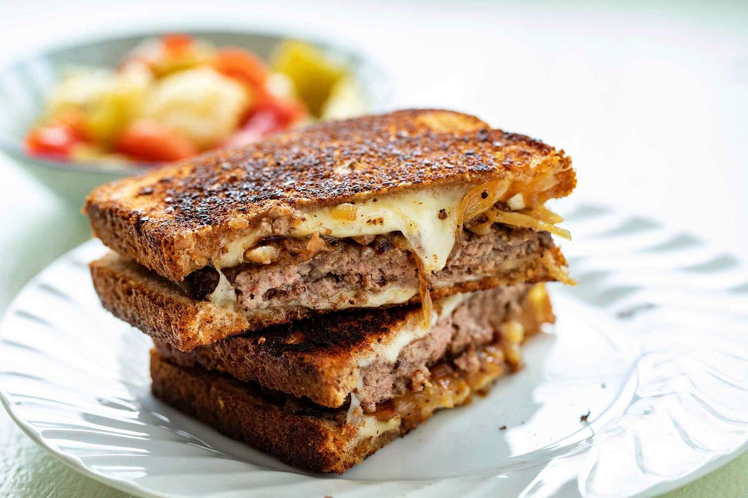 A sliced patty melt ready to eat