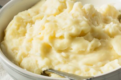 Creamy mashed potatoes in a white bowl