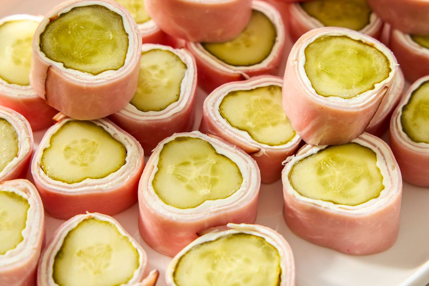 Slices of pickle cream cheese rollups with ham