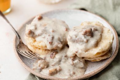 Biscuits and gravy on a plate.
