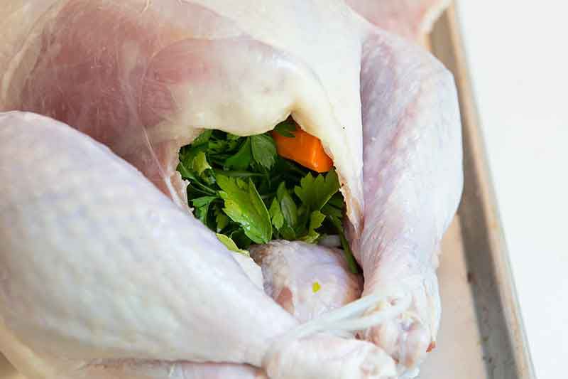 How to cook a turkey by stuffing aromatics in the cavity.