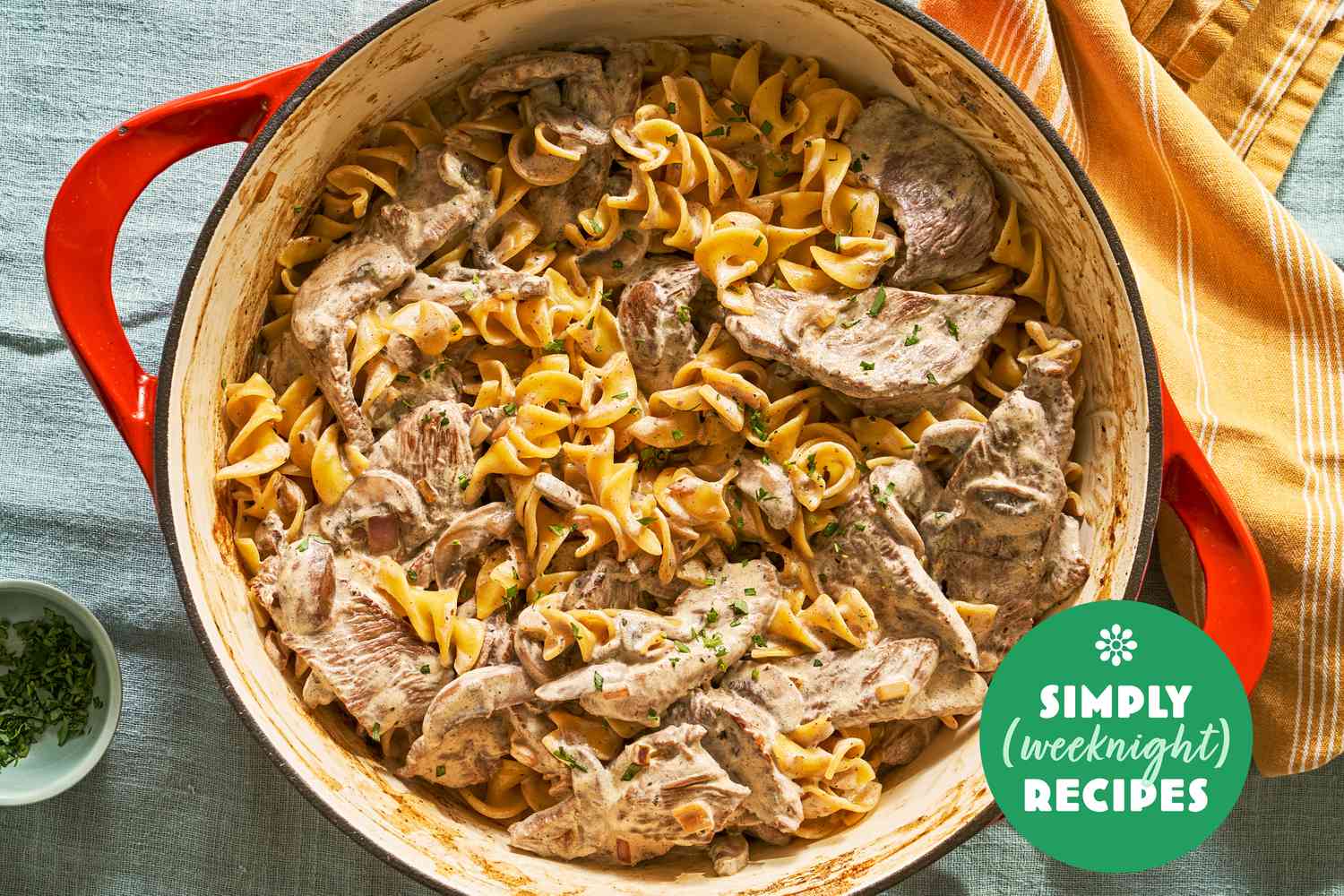 Beef stroganoff with noodles in a red pot