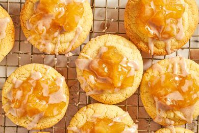 Baked cookies with an apple topping placed on a cooling rack