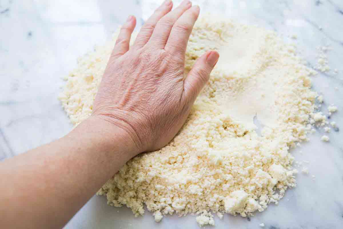 press pie dough with heal of your hand to smoosh some of the butter
