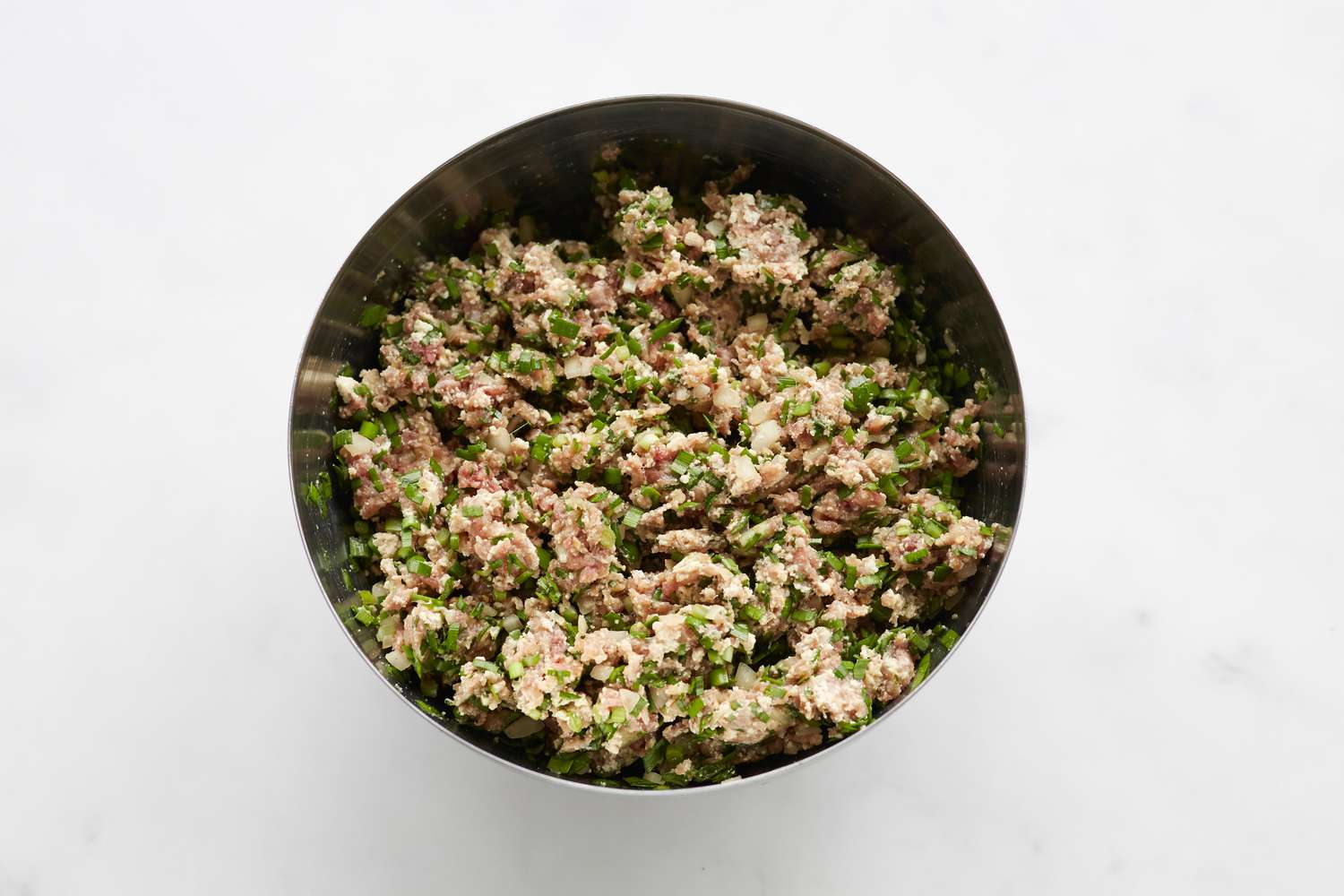 Pork, tofu, and beef filling to make Korean pork and chives dumplings.