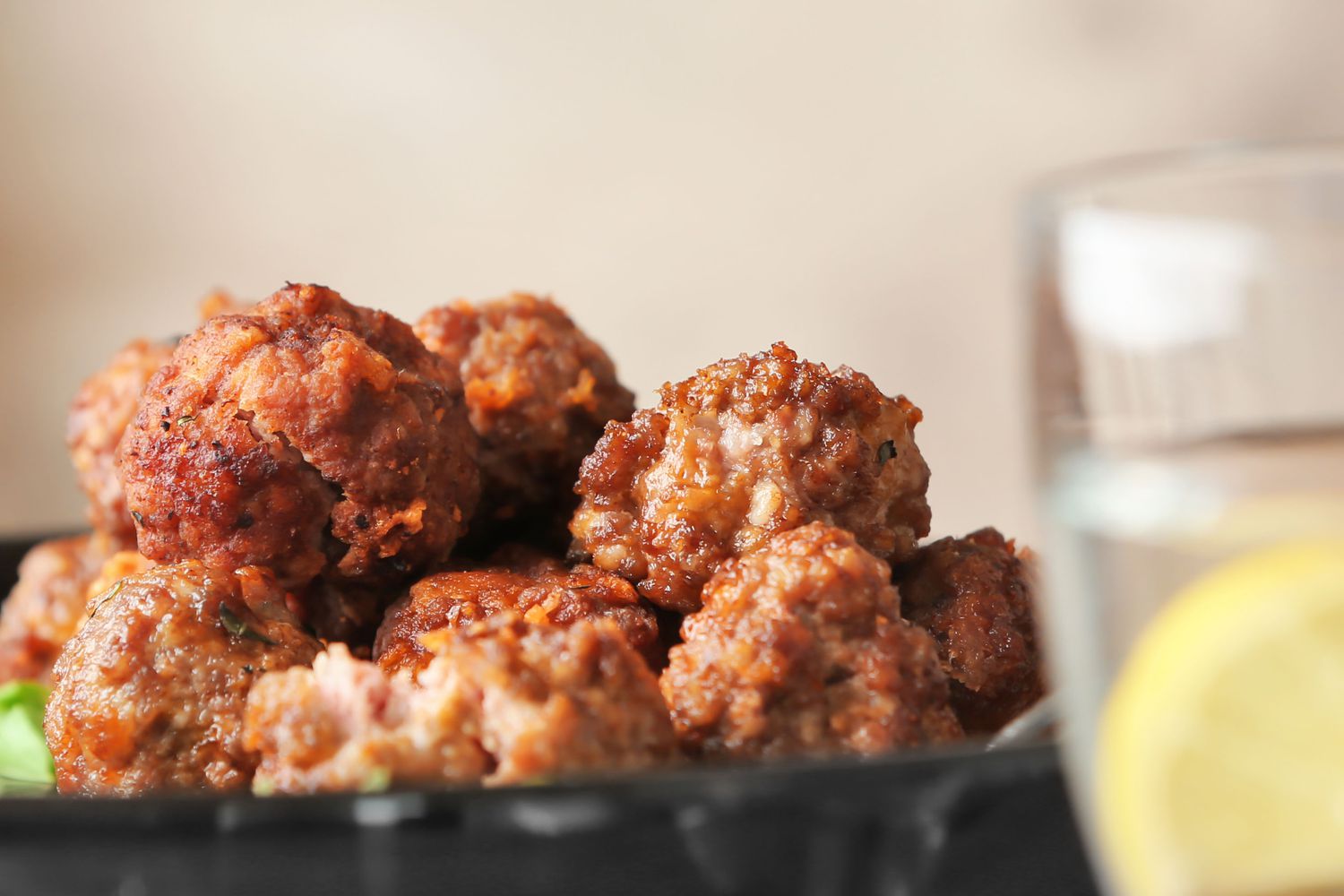 Plate with tasty sausage cheese balls on table