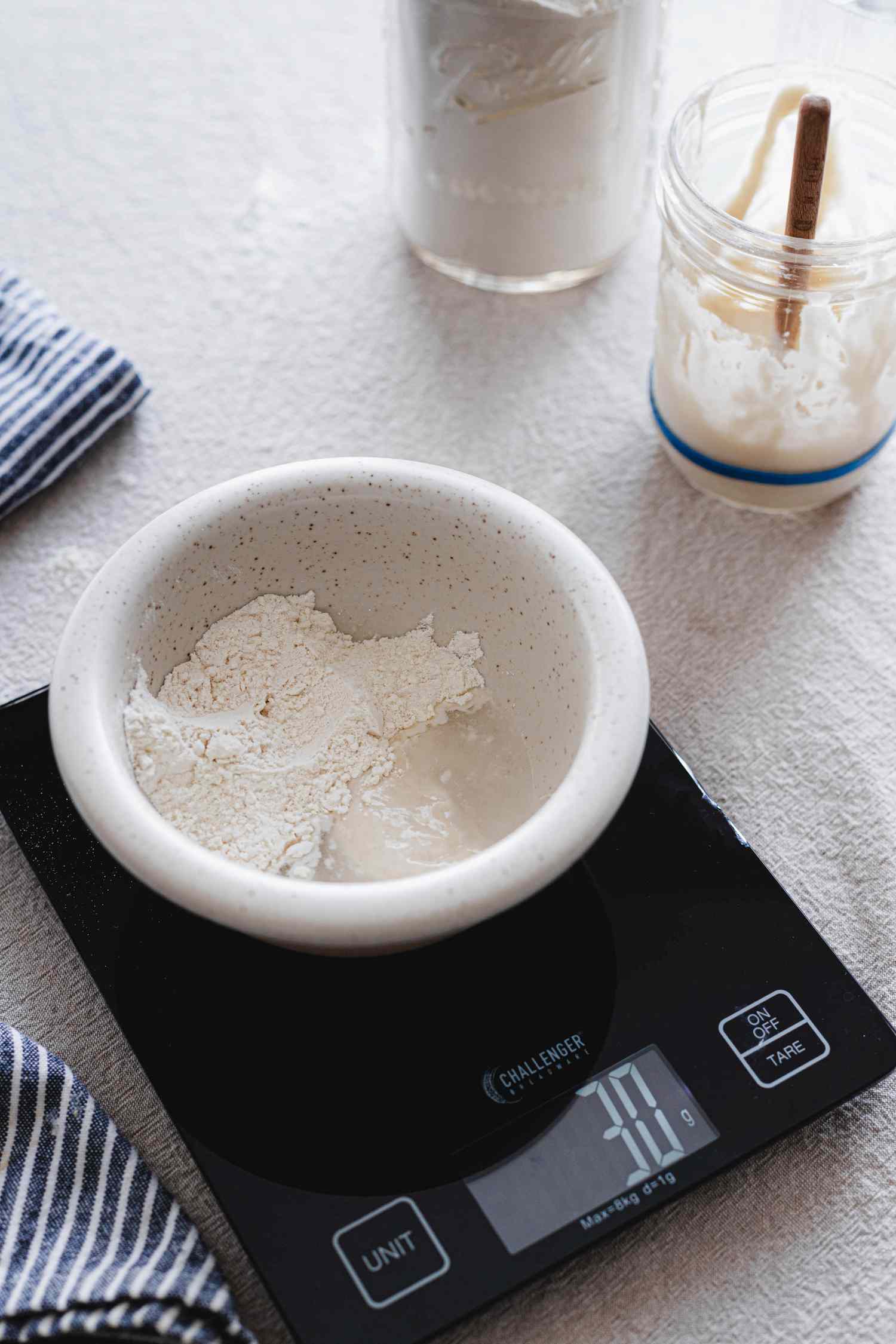 How to make your own sourdough starter in a small bowl on a scale.