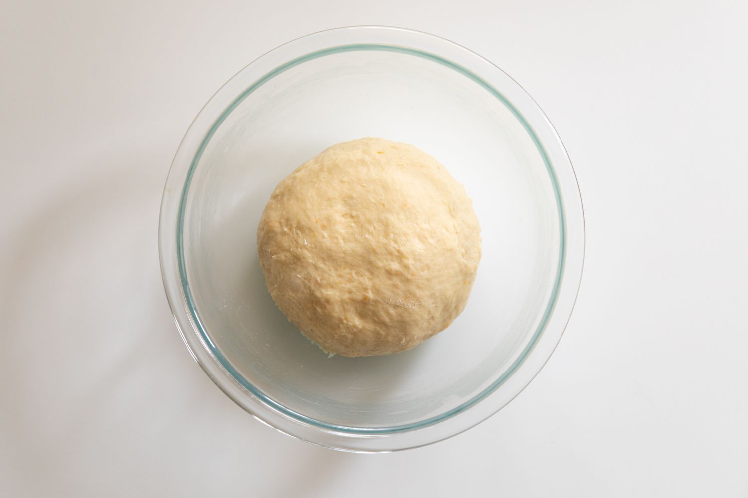 Dough in a bowl for pecan cinnamon rolls.