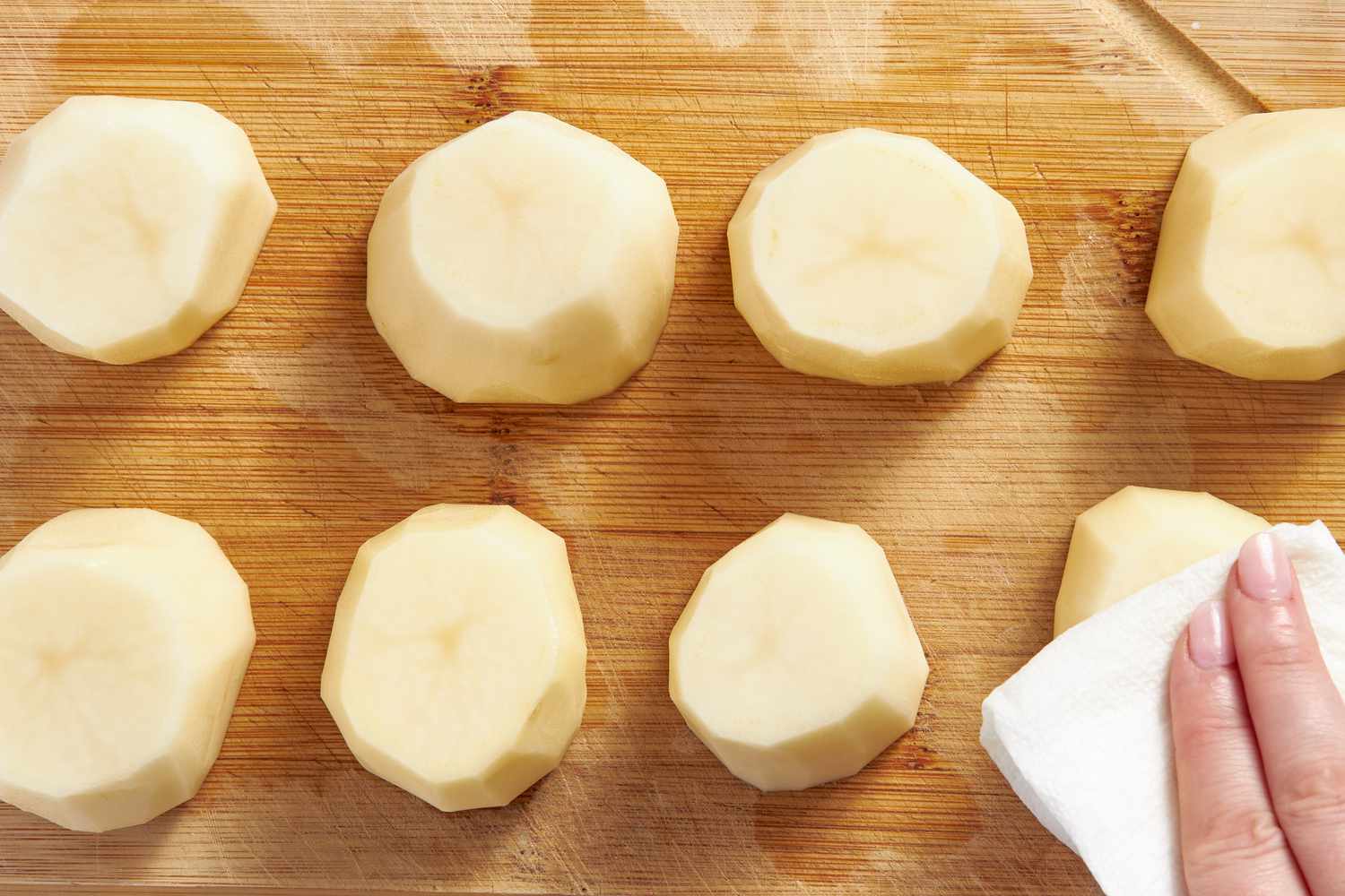 Paper towel used to remove excess moisture from russet potatoes for fondant potatoes recipe