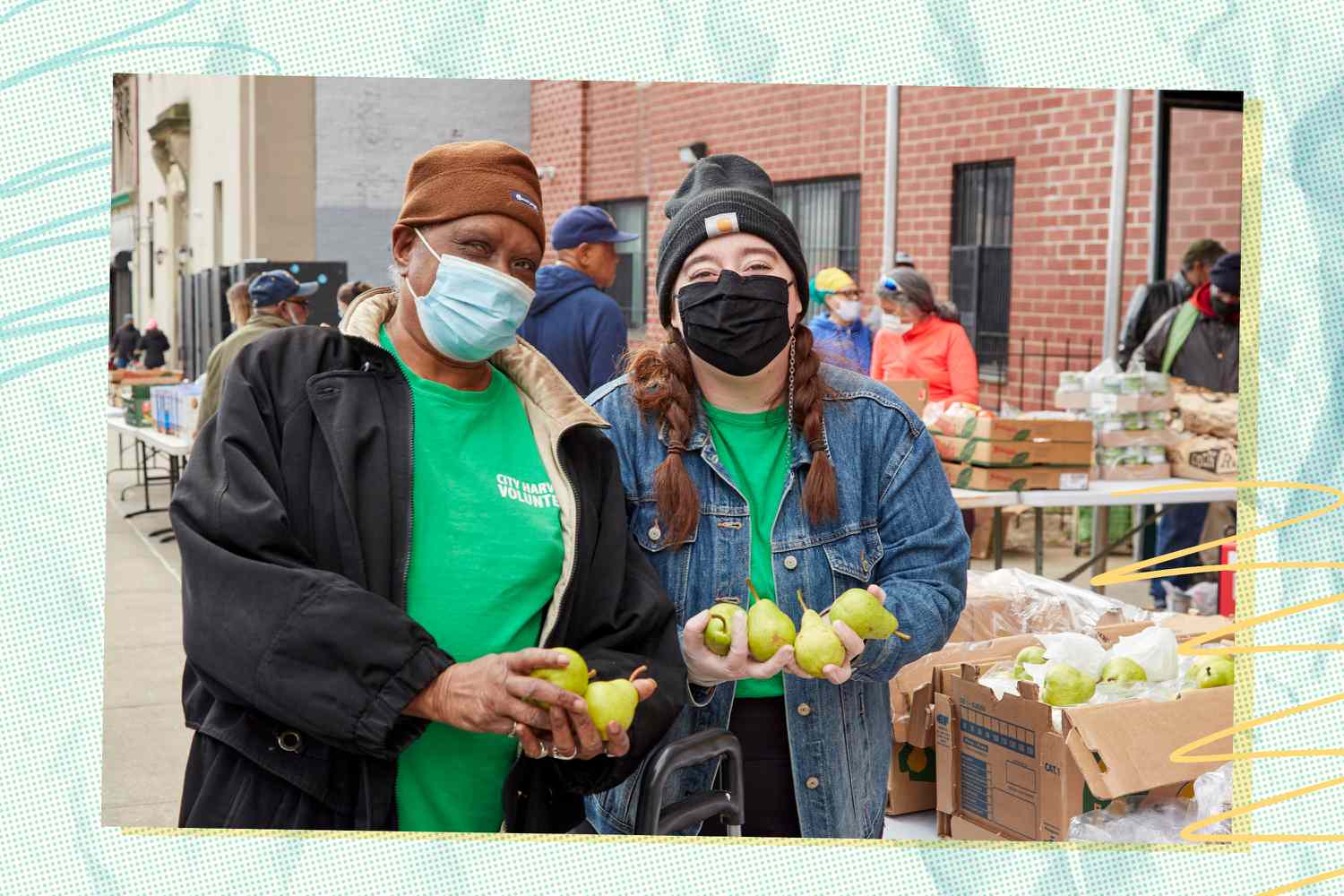 Two people from City Harvest holding fruit
