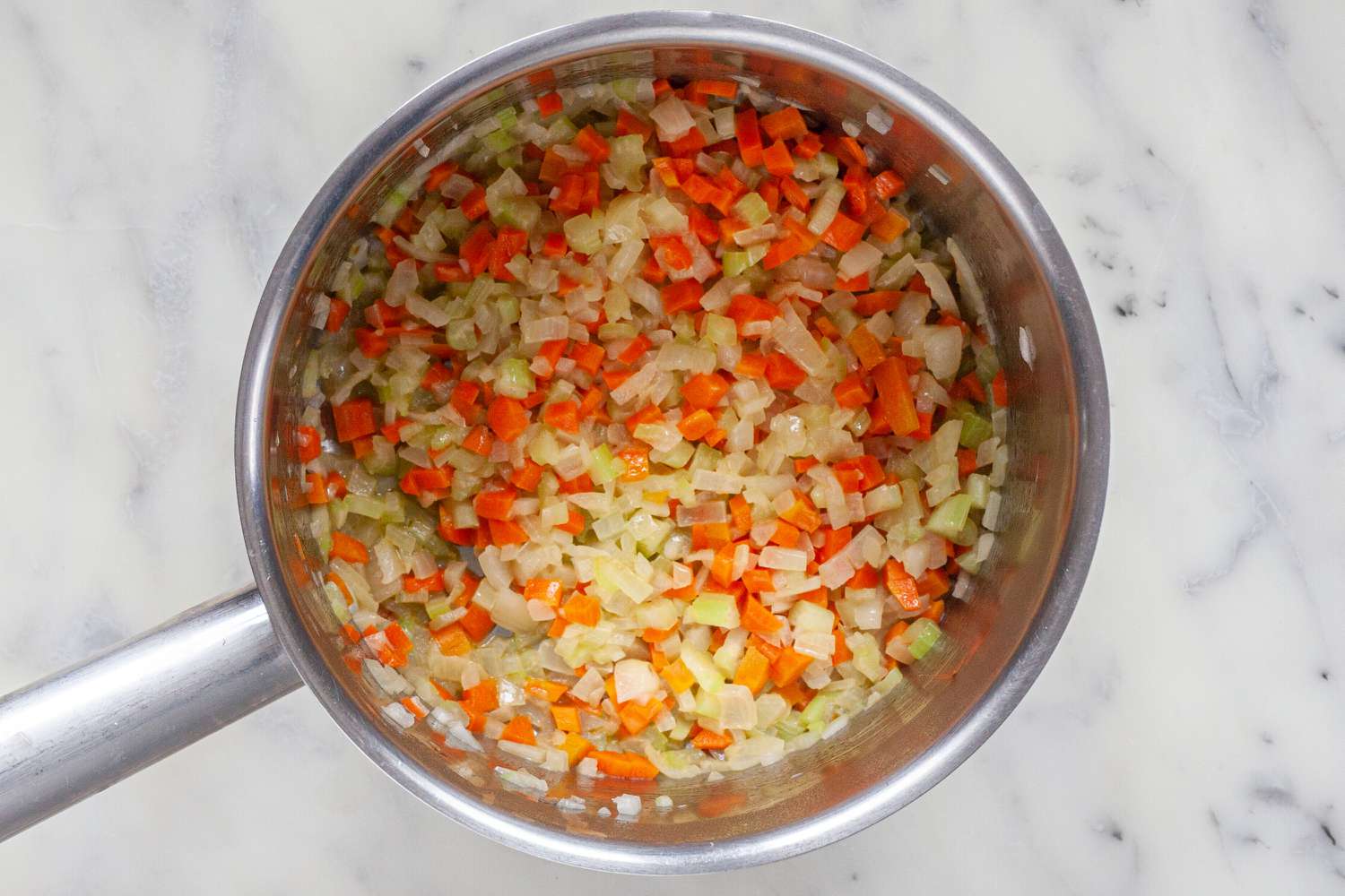 Onions, celery, and carrots in pot for classic espagnole sauce