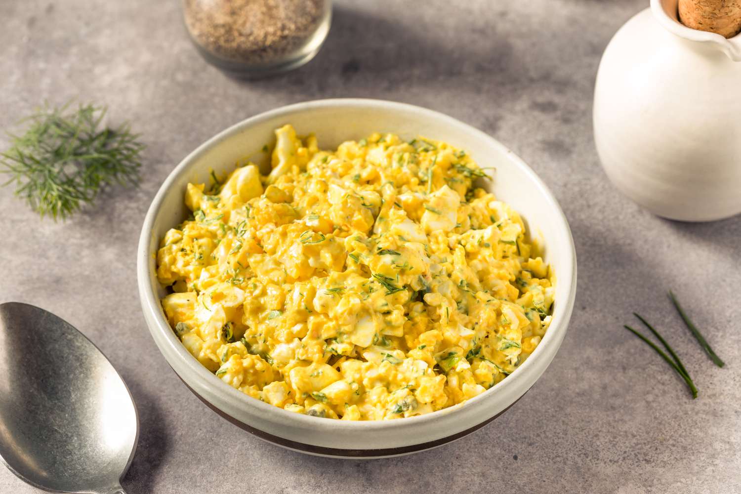 A white bowl with egg salad