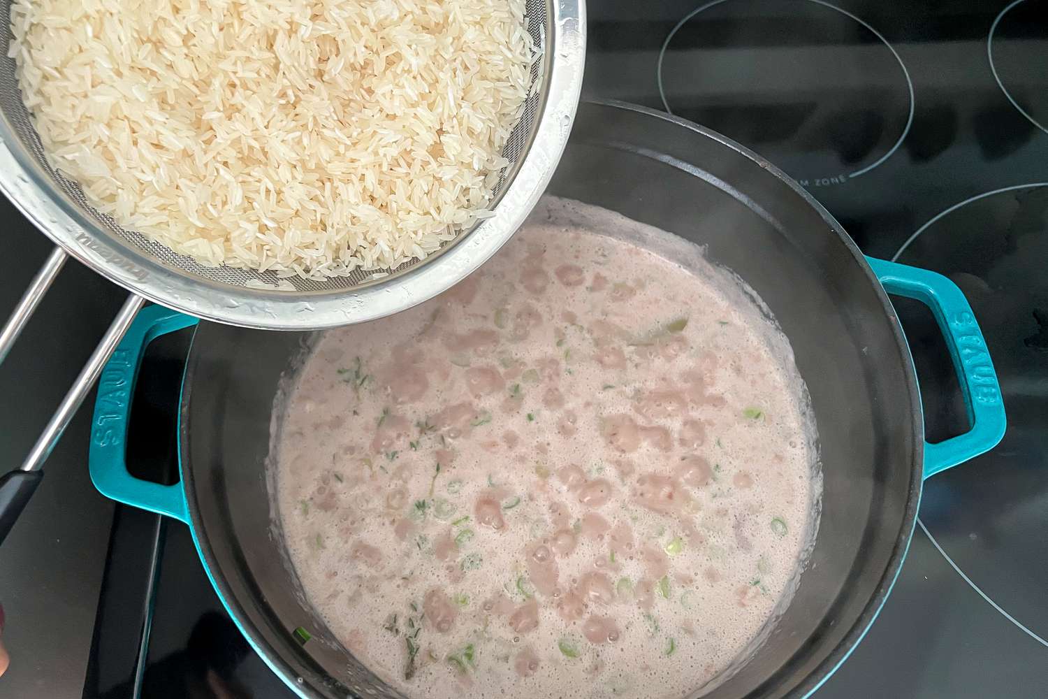 Add Rice to Beans in Dutch Oven for Jamaican Rice and Peas