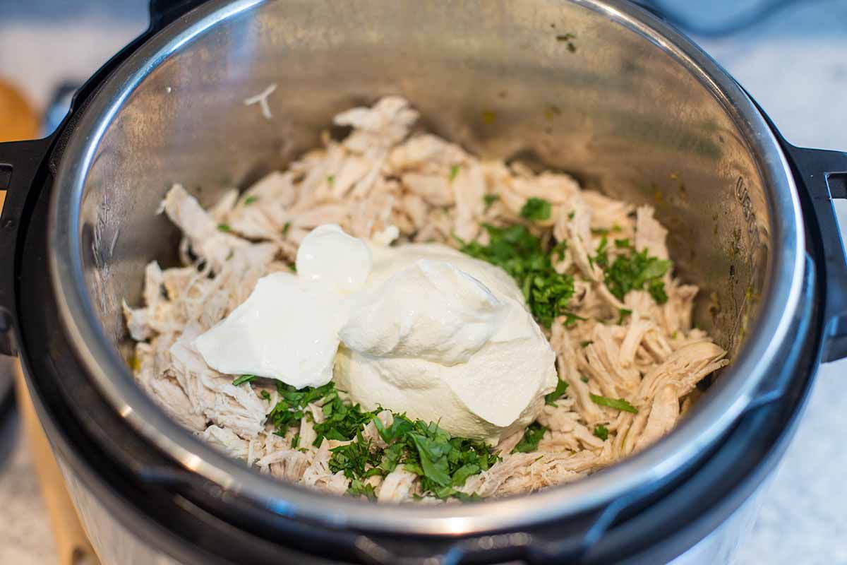 Best White Chicken Chili add the sour cream and cilantro