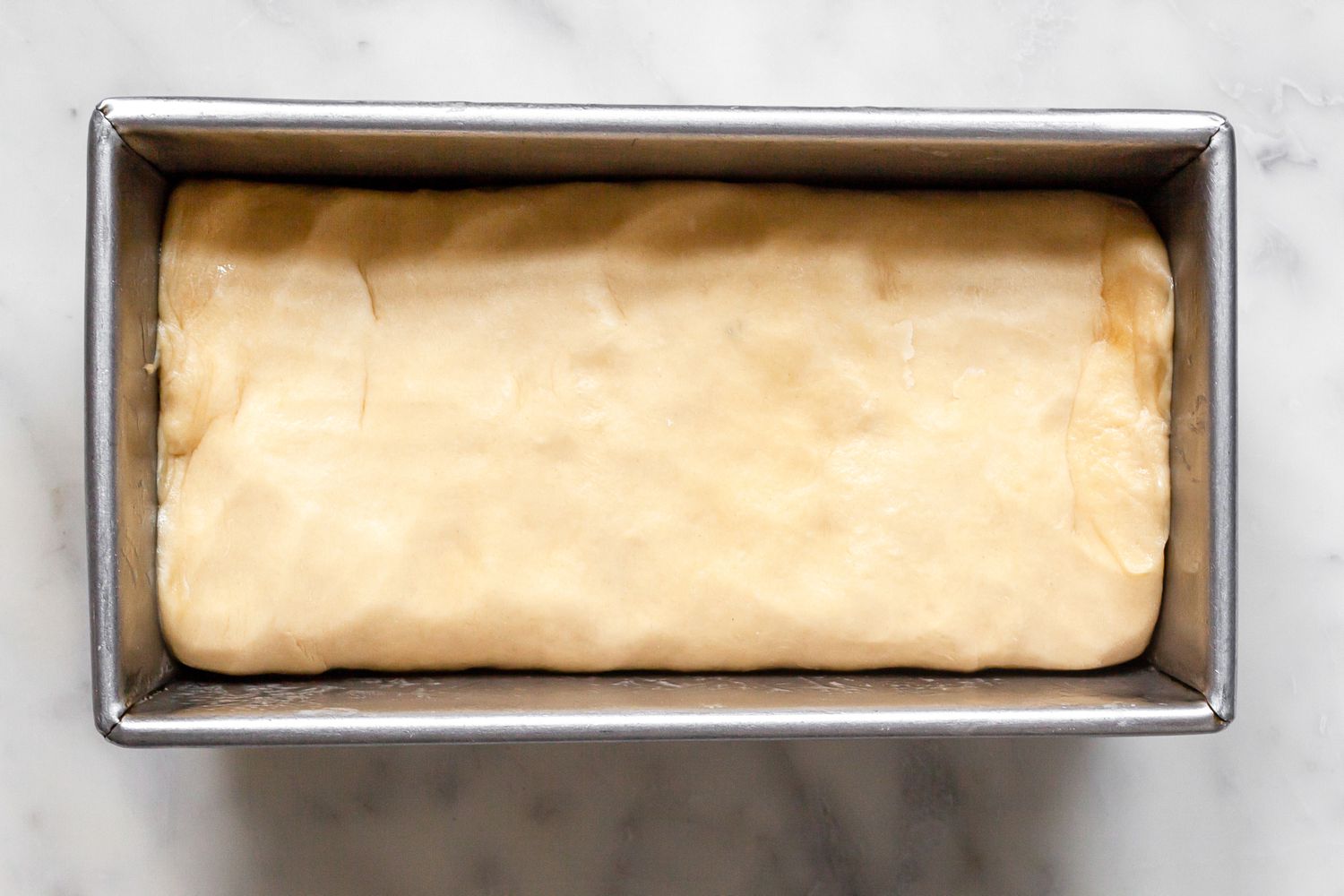 Brioche Sandwich Loaf Dough Flattened into the Loaf Pan 