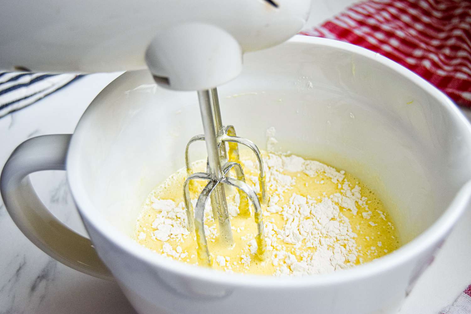 Hand mixer making a buttermilk pie recipe.