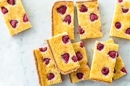 Raspberry chess pie bars cut and stacked.