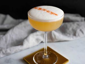 Whiskey sour cocktail with egg white foamy top