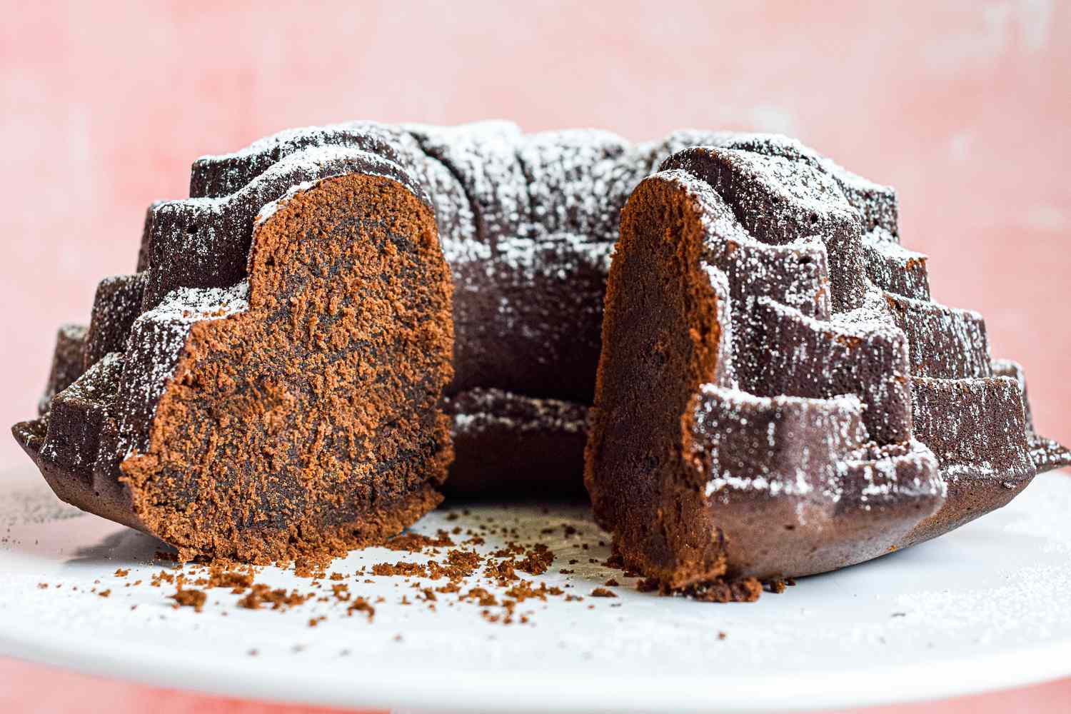 Chocolate Bourbon Cake on a cake stand with a giant slice out of it