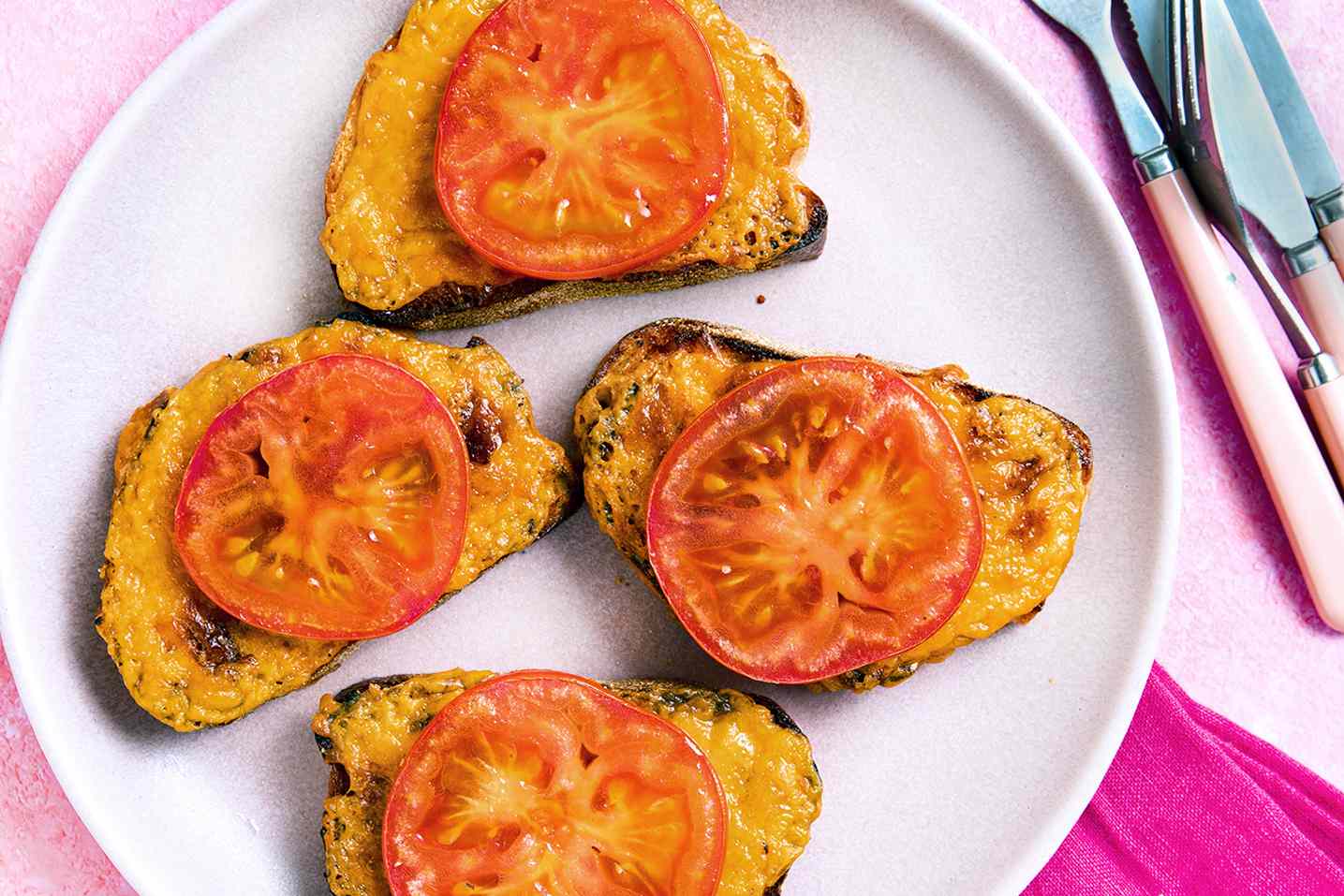 Welsh rarebit on a plate topped with tomato slices