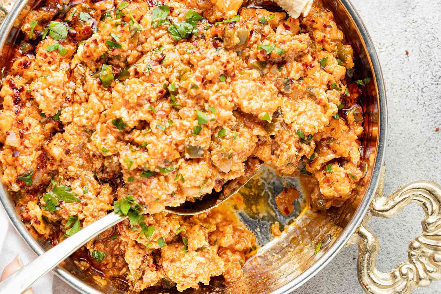 Menemen (Turkish Scrambled Eggs and Tomatoes) with Some Lifted on a Spoon